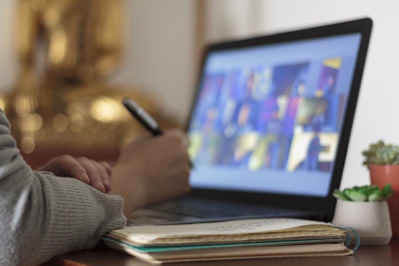 Leader conducting a virtual meeting with remote team members on a video call.