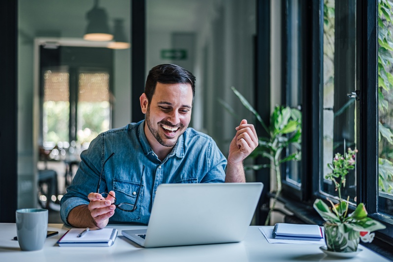 A relaxed professional working calmly in a clean, organised office space, representing balance and stress-free productivity.