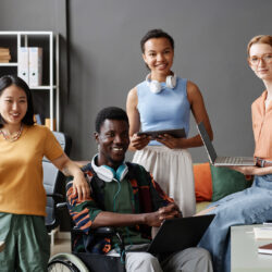 Diverse business team, including a wheelchair user, brainstorming ideas in the office