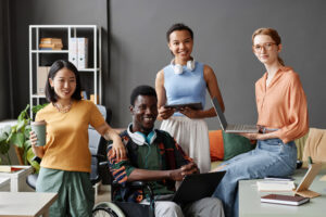 Diverse business team, including a wheelchair user, brainstorming ideas in the office